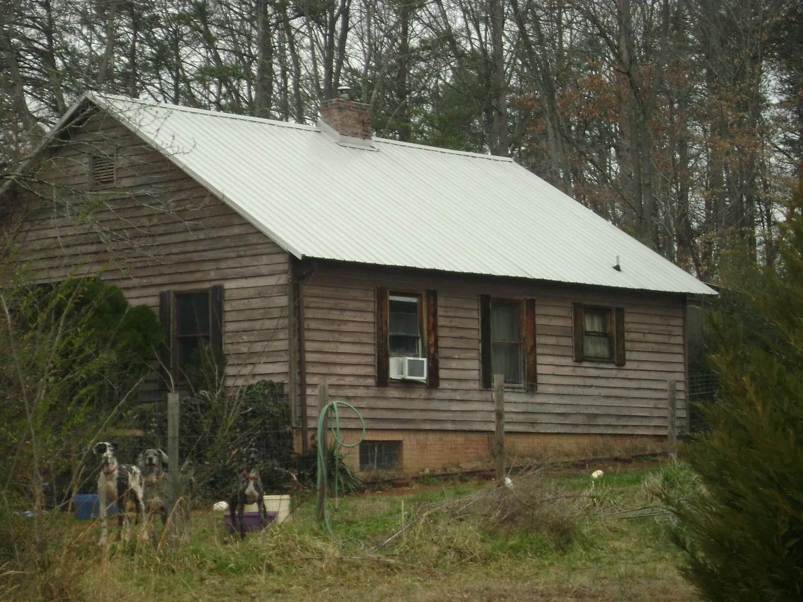White metal roof on an old wood sided farmhouse, from a Metal Roof Installation job in Jenkinsville